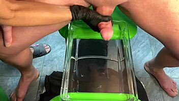 mature milf gives sensual handjob leading to cumshot in aquarium setting with muscular bodybuilder vibes.