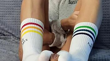 In the dorm room a cute petite girl next door bought special socks to playfully tease her roommate's interest