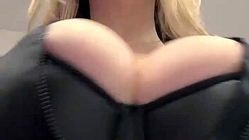 Big natural tits strain against the tight elastic leather material in a juicy display