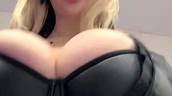 Big natural tits strain against the tight elastic leather material in a juicy display