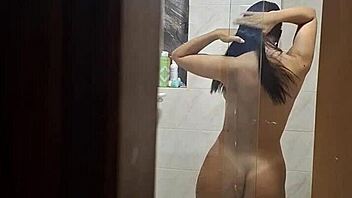 I secretly watch my attractive roommate as she undresses, uses the bathroom, and showers in private moments.
