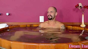 Bearded guy sucks Lia Dotada's big black shemale cock.