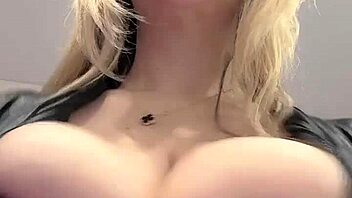 Big natural tits strain against the tight elastic leather material in a juicy display