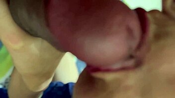 Indian woman and young guy share hotel bed in clear conversation during their encounter.