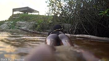 Skinny dark skinned African hottie contrasts teasing softness in the water