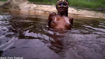 Skinny dark skinned African hottie contrasts teasing softness in the water