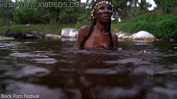 Skinny dark skinned African hottie contrasts teasing softness in the water