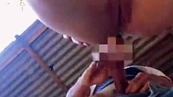 Excited couple enjoys outdoor fun behind abandoned house