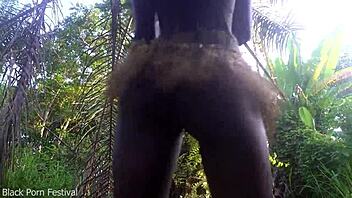 Hey, check out this perfect body dark skin African girl dancing half naked outdoors in raffia!