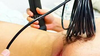 vietnamese girl explores her wet hairy pussy with toys in bedroom closeup.