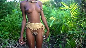 Hey, check out this perfect body dark skin African girl dancing half naked outdoors in raffia!