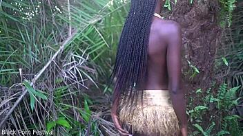 Hey, check out this perfect body dark skin African girl dancing half naked outdoors in raffia!