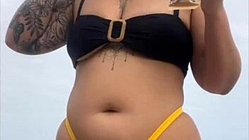 Wearing a tight yellow bikini that highlights her figure to draw attention at the beach
