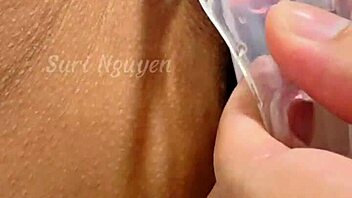 vietnamese girl explores her wet hairy pussy with toys in bedroom closeup.