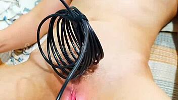 vietnamese girl explores her wet hairy pussy with toys in bedroom closeup.