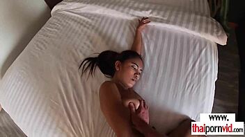Petite inked amateur Thai teen 18+ Cherry explores the hotel bed with enthusiasm