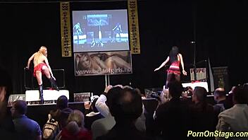 Horny babes sharing big cock on public sex fair stage outdoors