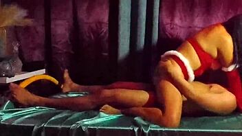 this cute mexican brunette in a sexy dress teases her friend with legs spread in homemade bedroom roleplay for christmas fun.