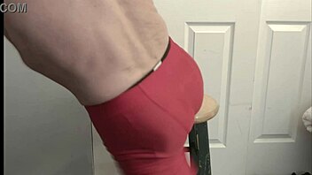 Grinding On Stool In Black Compression Tights And Red Compression Shorts For Intense Leg And Ass Workout Display