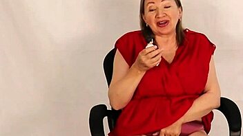 Busty giantess granny towers over tiny guy, playing with her huge natural tits in taboo homemade fun during old and young encounter.