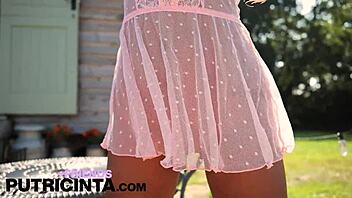 Asian babe Putri Cinta spreading legs to reveal shaved pussy