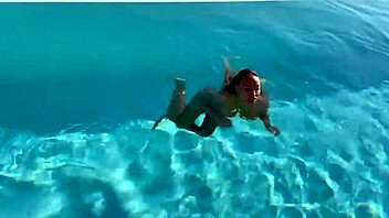 gorgeous monika fox swims naked in the pool at a beautiful outdoor location, showing off her big tits and pierced nipples