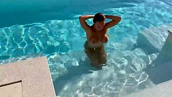 gorgeous monika fox swims naked in the pool at a beautiful outdoor location, showing off her big tits and pierced nipples