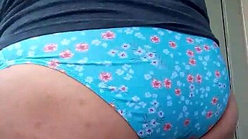 He secretly enjoys slipping into his wife's teasing panties for personal thrill.