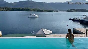 gorgeous monika fox swims naked in the pool at a beautiful outdoor location, showing off her big tits and pierced nipples