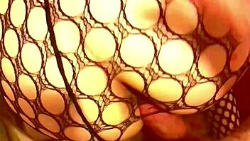 Sexy girl flaunts ass in fishnet lingerie and thong