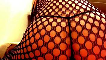 Sexy girl flaunts ass in fishnet lingerie and thong
