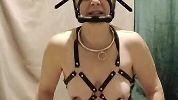 bound milf maid chained in harness submits to dildo humiliation