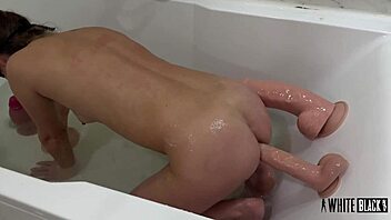 How does master's giant dildos stretch this submissive anal slave's tight holes?
