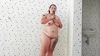 Chubby BBW Exposes Saggy Tits And Fucks Pussy With Dildo In Public Pool Showers