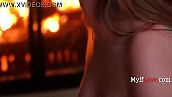 Jessie Rogers poses seductively by the fireplace in cozy setting MylfLove