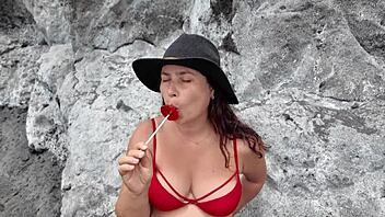 a busty euro milf sucks candy on beach then real cock