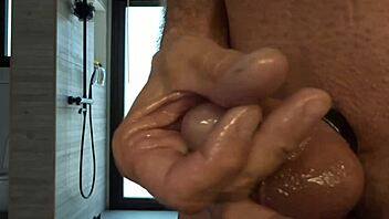 guy plays with his small oiled cock during masturbation session