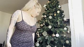 Big titted blonde teases her pussy by the christmas tree