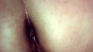 A woman endures firm spanks on her rear while engaging in intense solo masturbation play in the bedroom