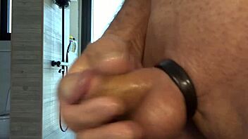 guy plays with his small oiled cock during masturbation session