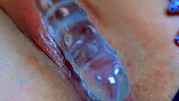 watch her puffy shaved pussy devour that glass dildo sensually