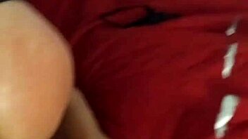 A woman endures firm spanks on her rear while engaging in intense solo masturbation play in the bedroom