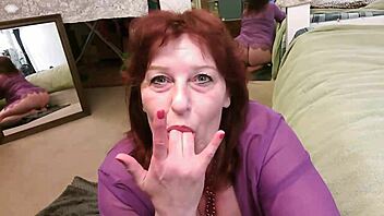 curvy mature slurps fingers with red lipstick