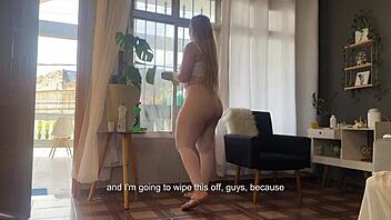 cleaning window in see-through pants revealing sexy ass