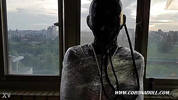 Bound in 1mm rubber mask for outdoor latex bondage play