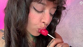 Split-tongue girl LICKS lollipop then slides it deep into her hungry ASS