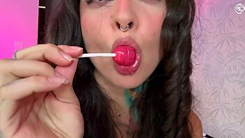 Split-tongue girl LICKS lollipop then slides it deep into her hungry ASS