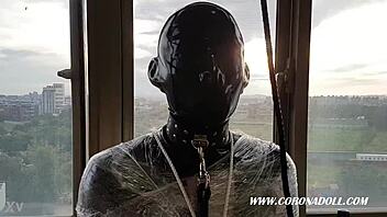 Bound in 1mm rubber mask for outdoor latex bondage play