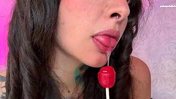 Split-tongue girl LICKS lollipop then slides it deep into her hungry ASS