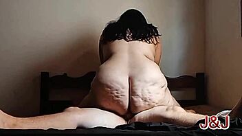 Tattooed chubby Brazilian femdom rides bull on bed